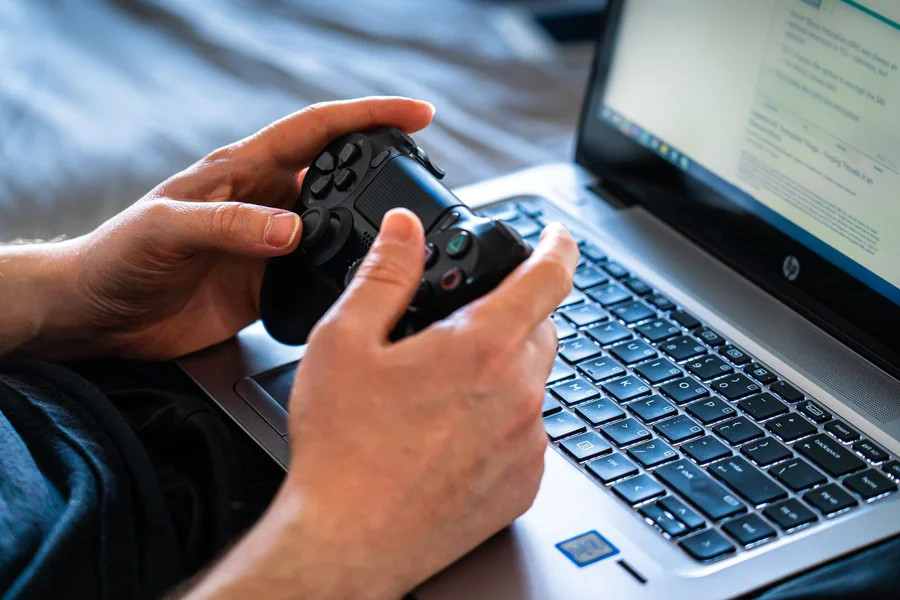 Gaming Laptop Performance A gamer playing an intense action game on a high performance gaming laptop