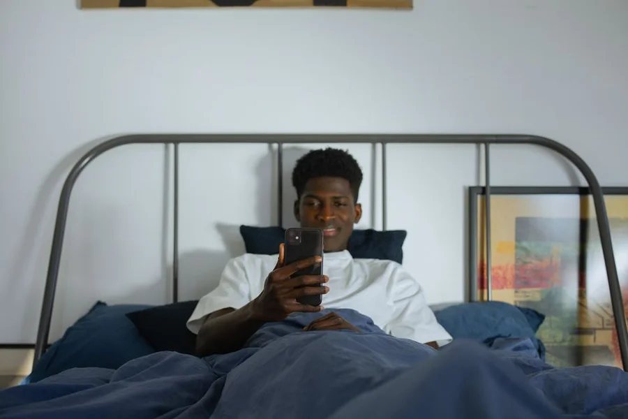 Modern Sleep Tech Devices A collection of modern sleep technology devices, including a smart ring, a sleep tracking mat, and a smart lamp, arranged on a bedside table.