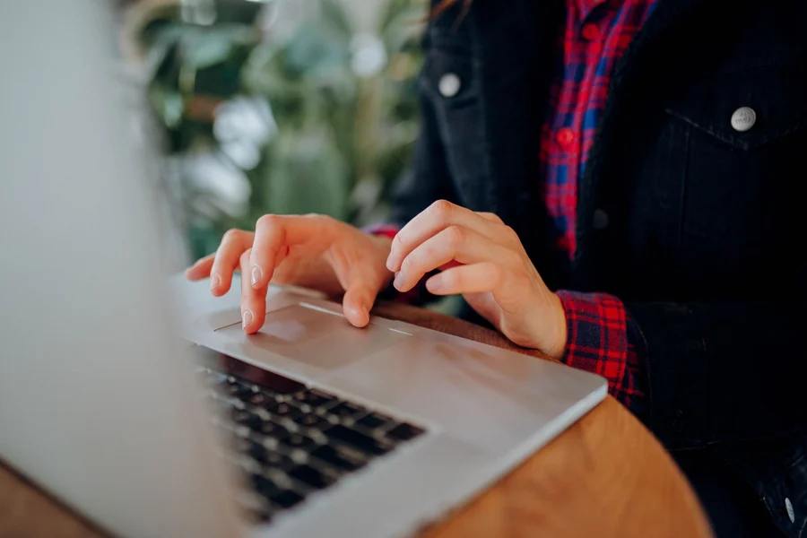 AI Assistant Research Setup A person interacting with a laptop interface to research free AI assistant platforms