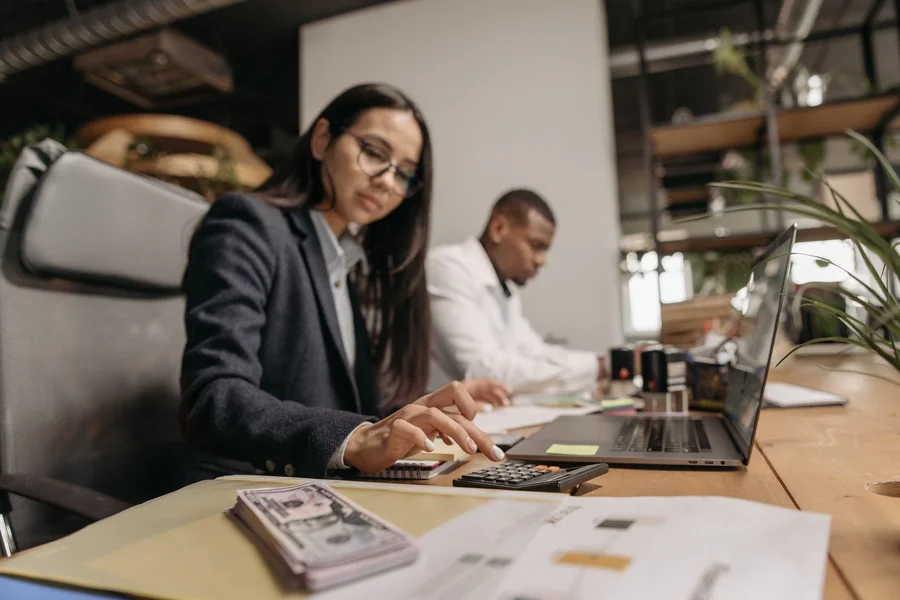 Small Business Financial Workspace A modern office workspace with a laptop, accounting documents, and coffee