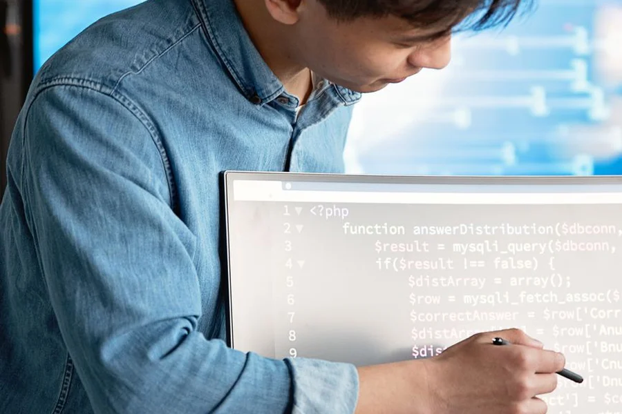 Professional AI Productivity Workspace A software developer analyzing complex data across dual computer monitors
