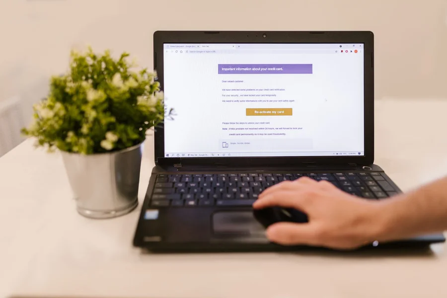 A user entering detailed text prompts into a laptop running ChatGPT