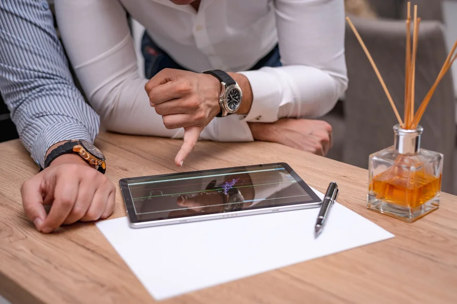 Operations Team Analyzing Workflow Diagram A business operations team analyzing workflow diagrams on a tablet screen