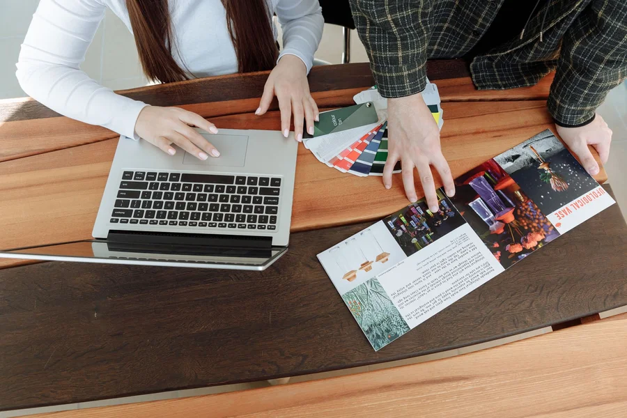 Creative Branding Team Collaboration A creative agency team collaborating on a branding color palette on a laptop screen