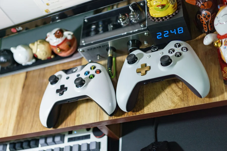 An Xbox wireless controller with a custom chameleon color-shifting iridescent faceplate on a desk