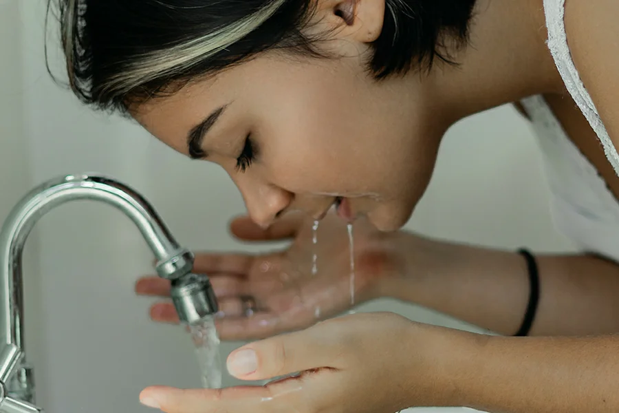 Washing face with warm water for clean tubing mascara removal
